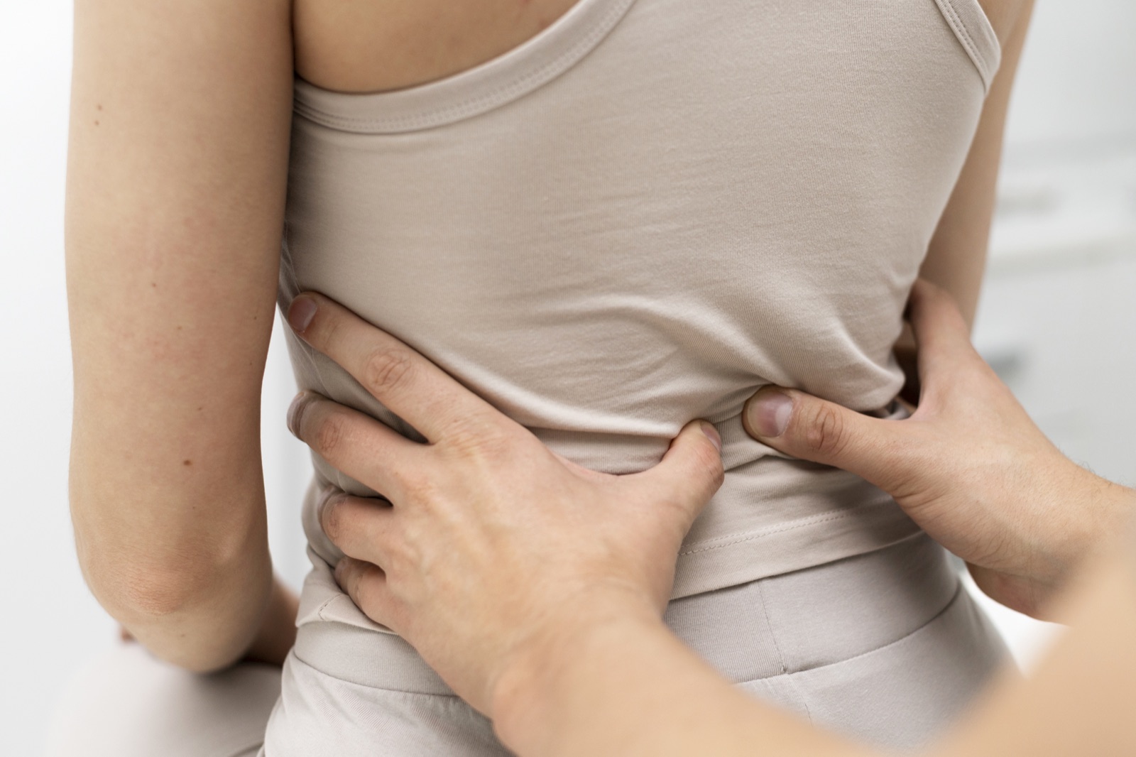 A clinician assessing a patient's lower back