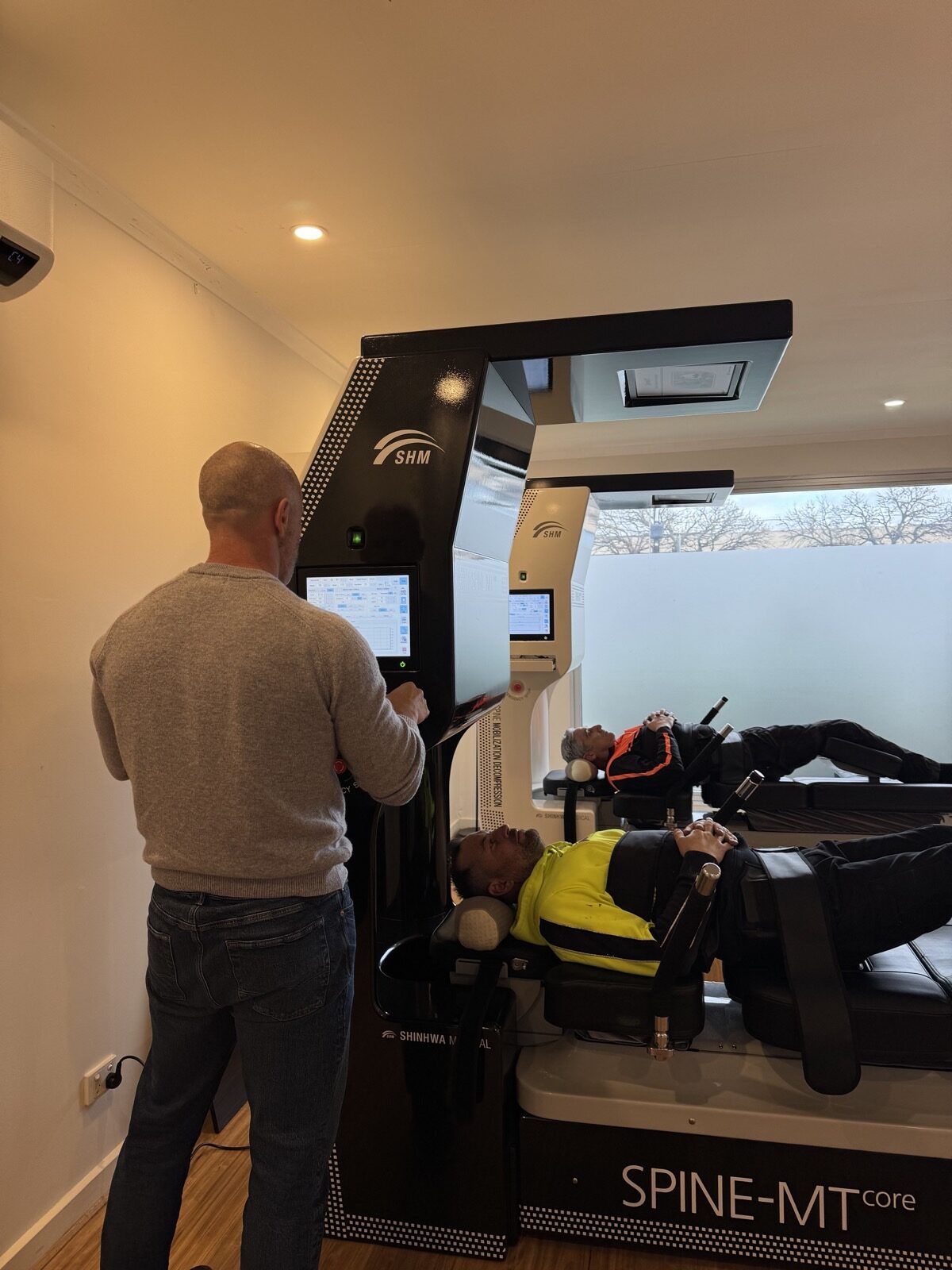 An MT Core Smart Decompression session in progress at Shift Spinal Health, with two patients receiving treatment